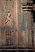 Banteay Srei temple - sculpted devata represented in a shrine, geese decorate the shrine